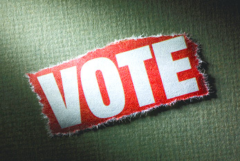 Un morceau de papier rouge avec l'inscription blanche >>VOTE